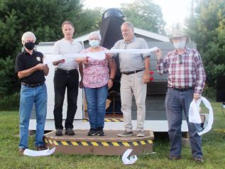 From left: Mayor Ron Higgins, Coun. John Inglis, Betty Hunter, astronomer Gary Caldwell and astronomer Guy Nason cut the ribbon to officially open the North Frontenac Sky Pad Observatory and Fred Lossing Telescope. Photo/Craig Bakay
